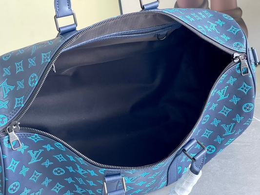 Os grandes homens marcados ensacam sacos azuis de Keepall BANDOULIÈRE 50 Boston